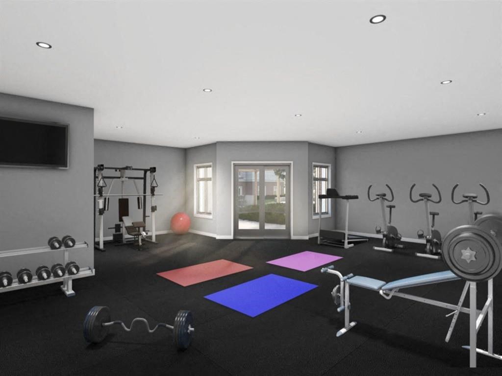 a gym with weights and exercise equipment and a tv