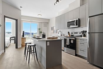 A modern kitchen with stainless steel appliances and a large island at The Woods at 180 Kanata Avenue, K2K 3L9