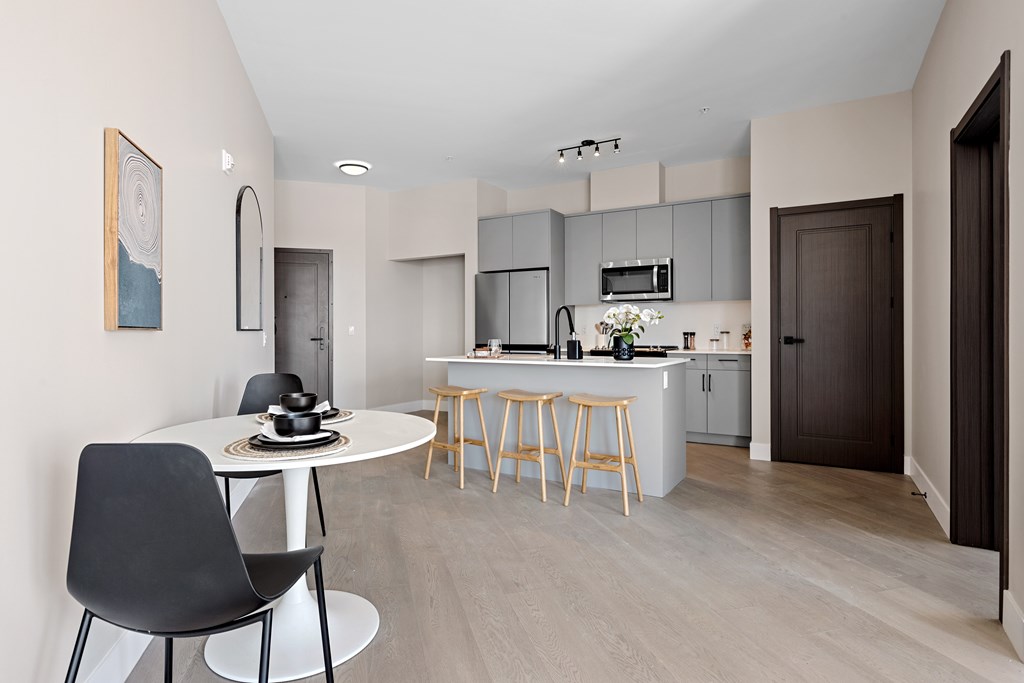 A modern kitchen with a dining table and chairs at The Woods at 180 Kanata Avenue, Kanata, ON, K2K 3L9