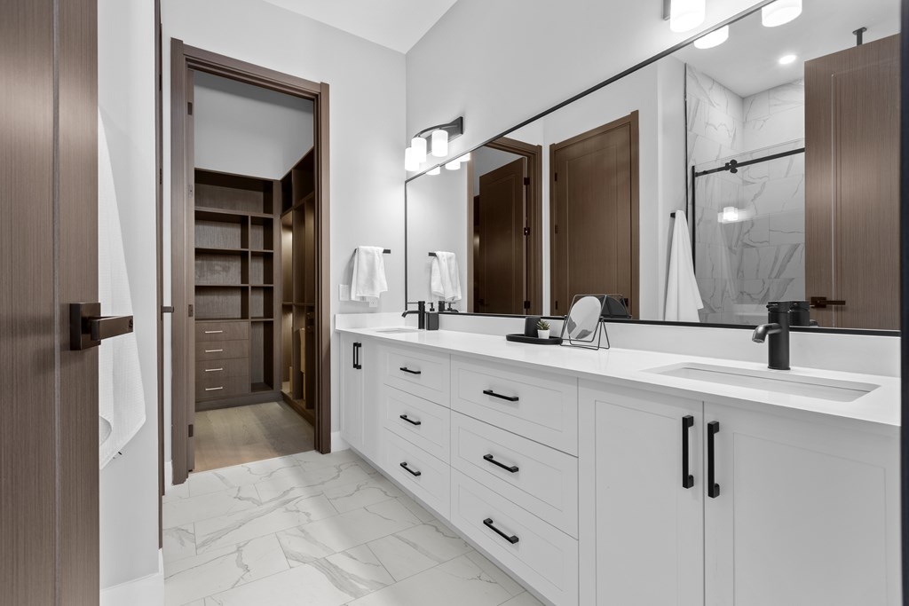 A bathroom with a white counter and a brown door at The Woods at 180 Kanata Avenue, Kanata