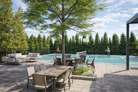 A large tree stands in the middle of a patio with a table and chairs.