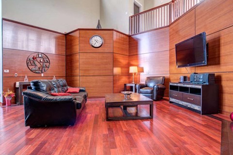 a living room with leather furniture and a television