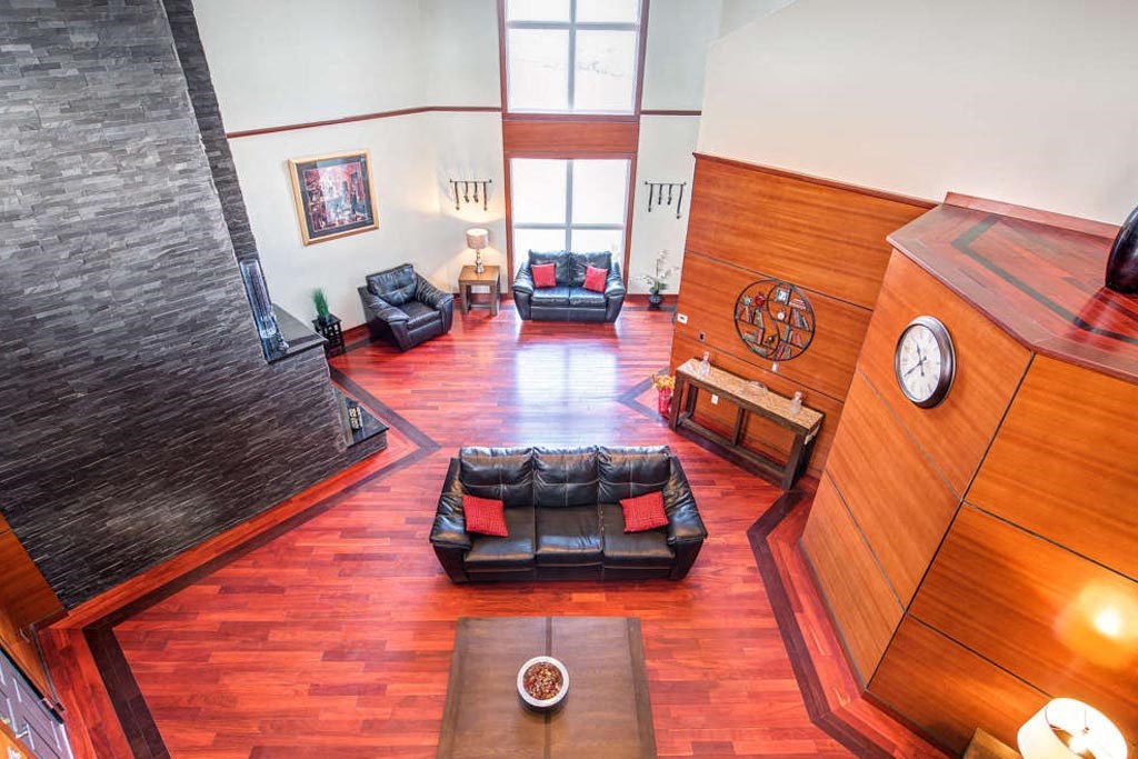 a living room with a couch and a clock on the wall