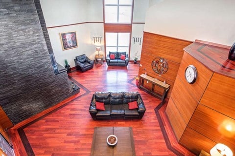 a living room with a couch and a clock on the wall