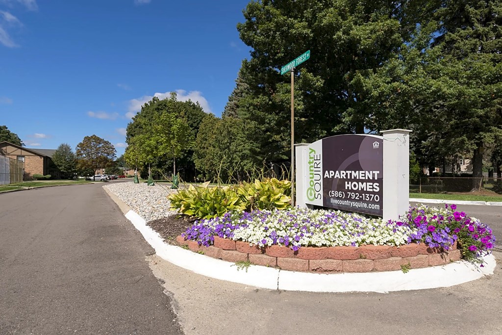 the sign for apartment homes at the end of a road