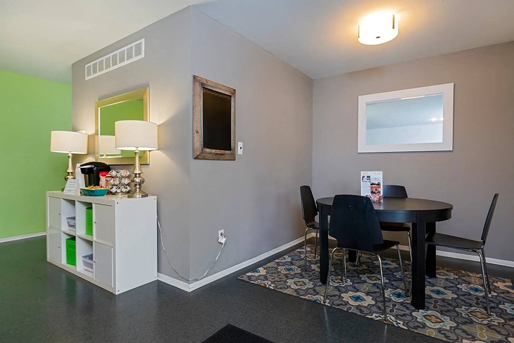 a dining room with a table and chairs and a window