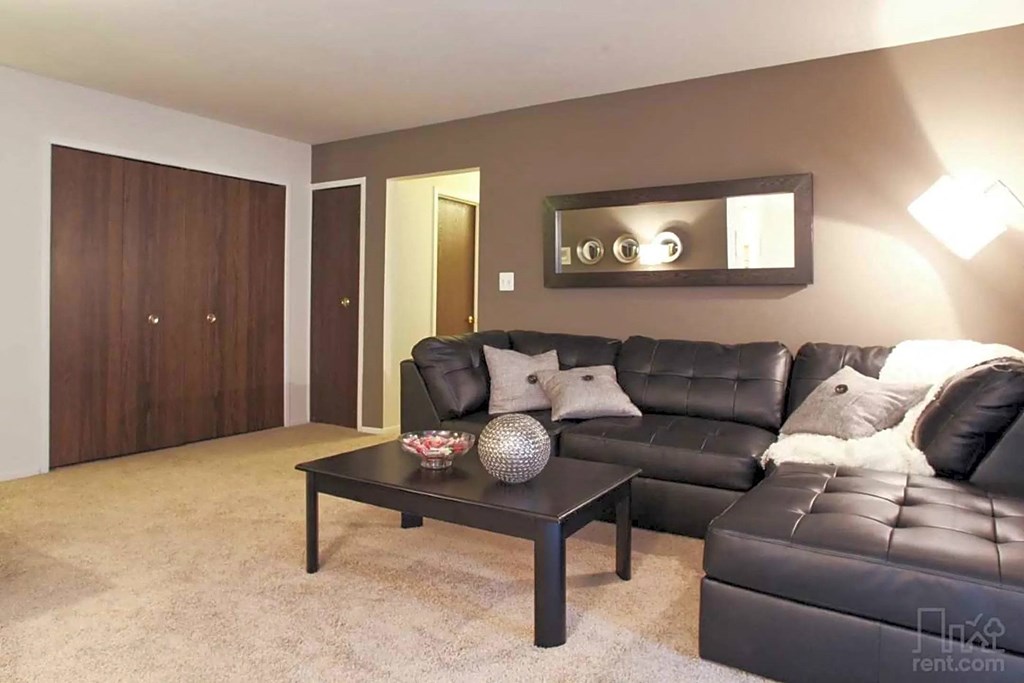 a living room with a leather couch and a coffee table
