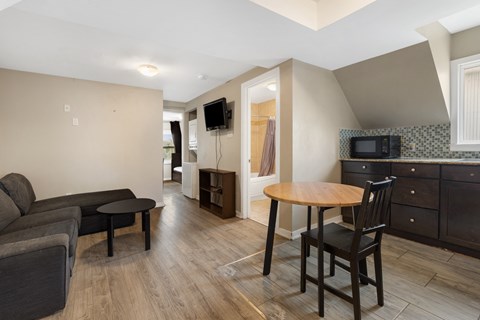 a living room and dining area with a small table and a couch