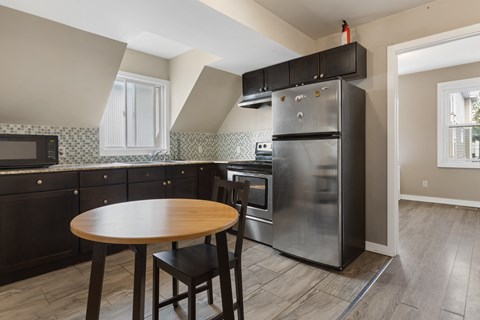 a kitchen with stainless steel appliances and a wooden table