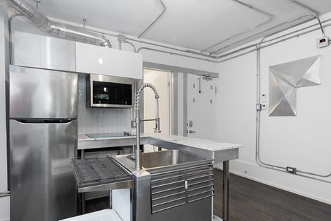 A modern kitchen with stainless steel appliances and a large island.