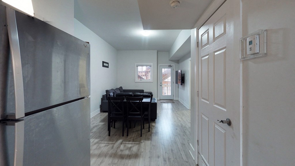 an empty living room with a black couch and a table