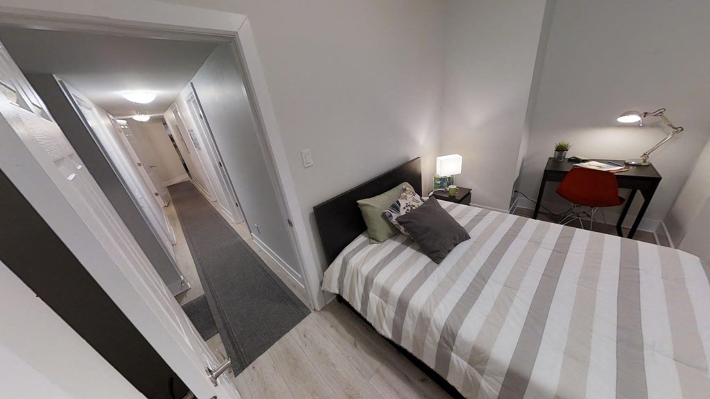 a bedroom with a bed and a mirror