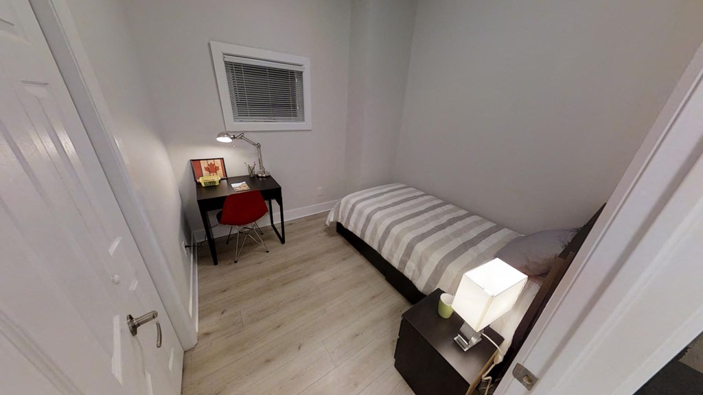 a small room with a bed and a desk