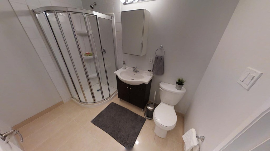 a bathroom with a toilet and a sink and a shower