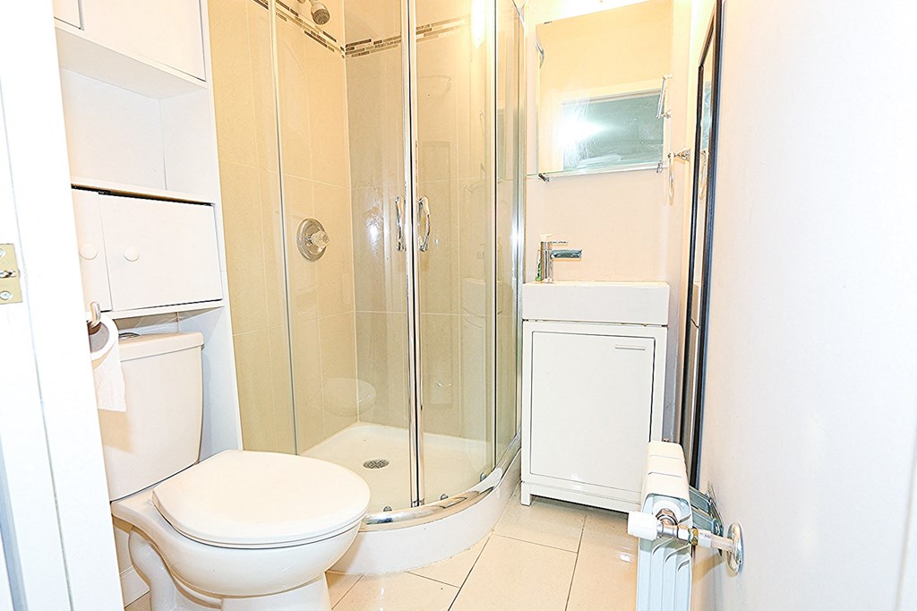 a bathroom with a toilet and a shower