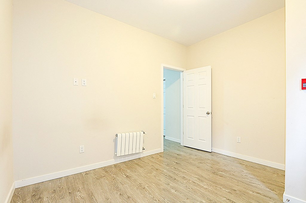 a empty room with a door and a wood floor