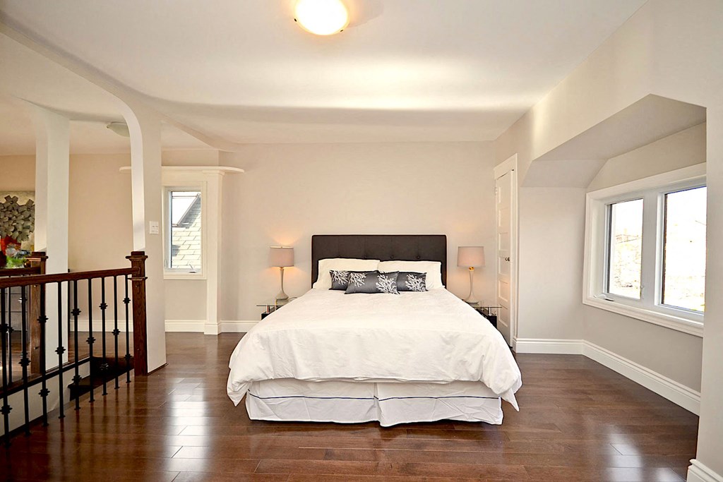 a bedroom with a bed and a staircase