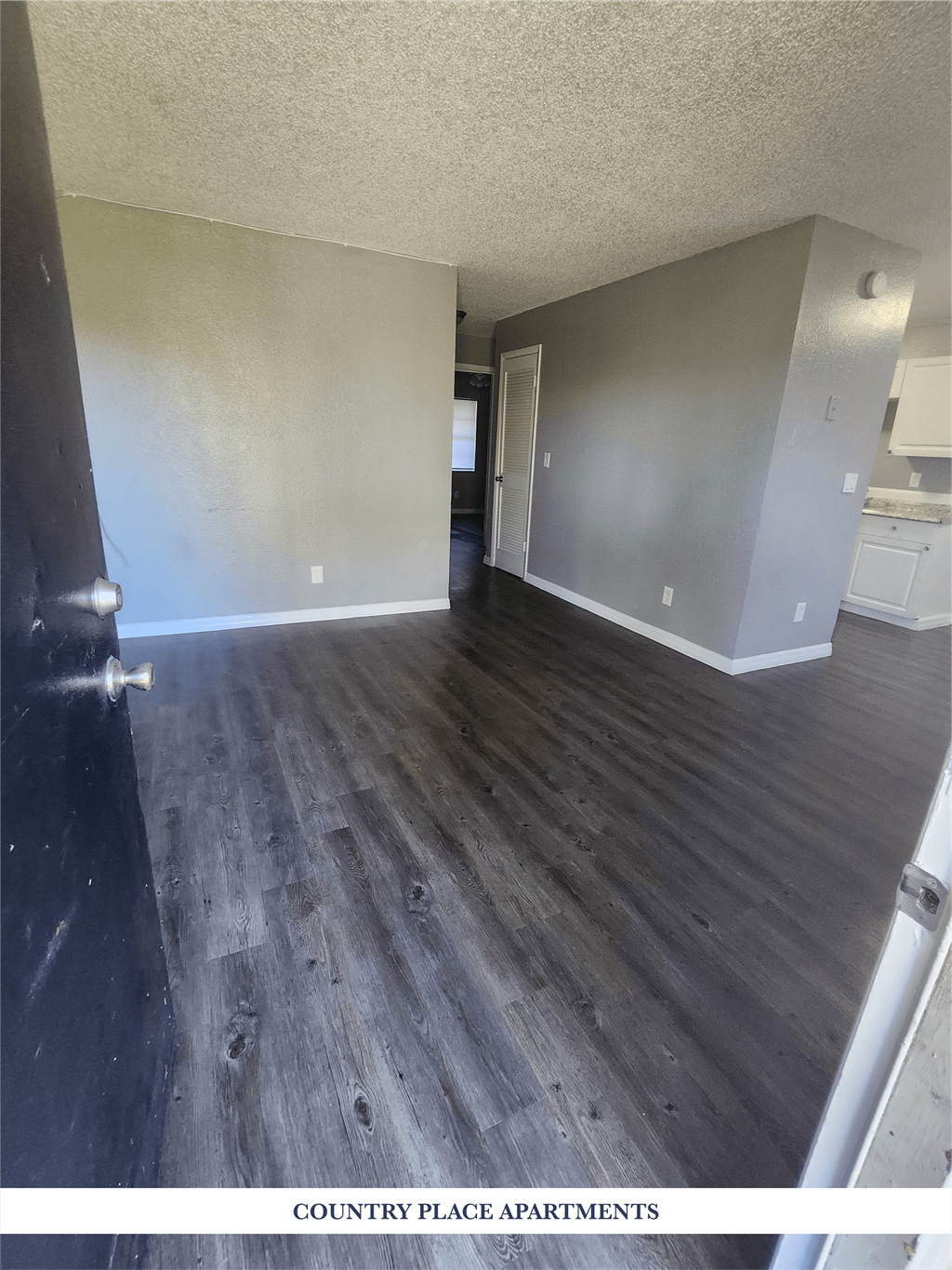 A kitchen area with a refrigerator, oven, and sink.