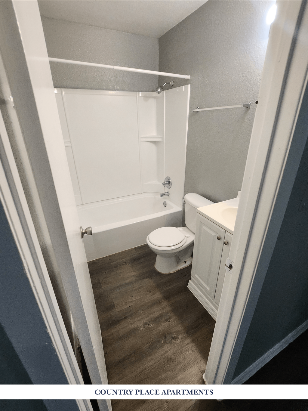 A small white bathroom with a toilet, sink and bathtub.