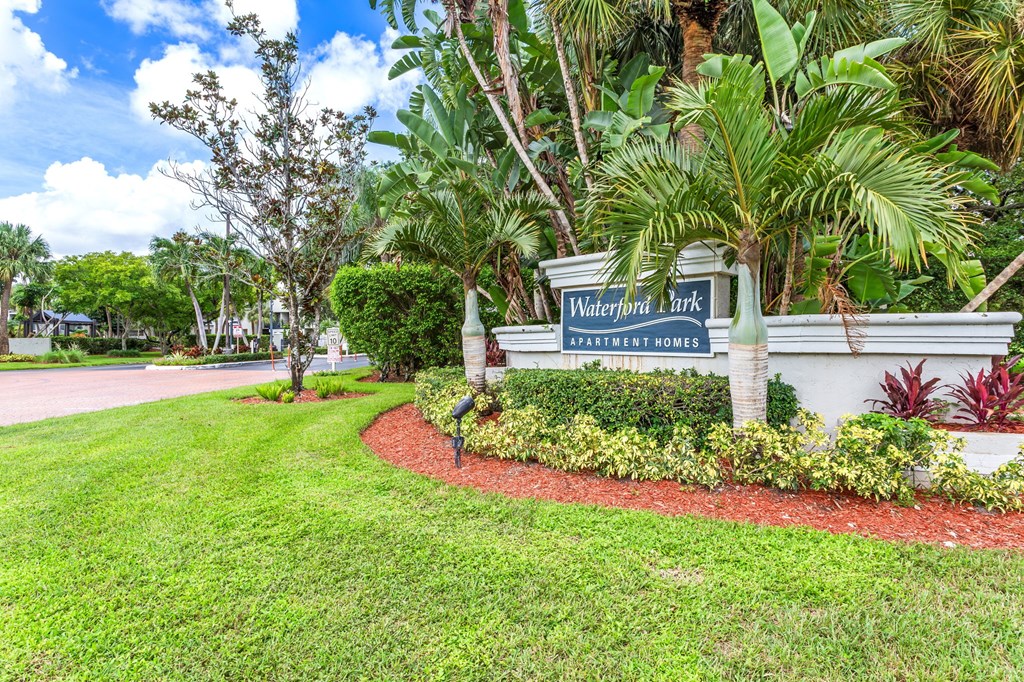 A sign for Waterfront Park is surrounded by greenery.