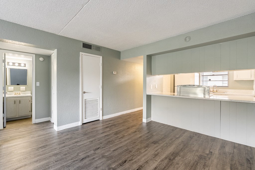 A room with a wooden floor and white walls.