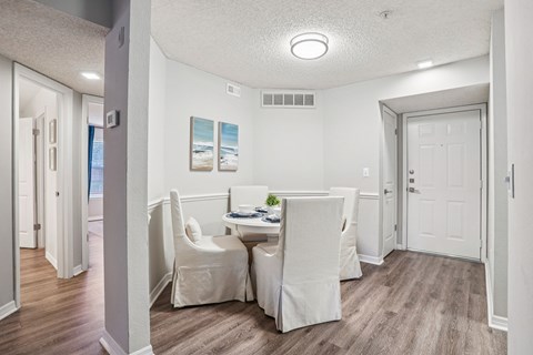 A dining room with a table and chairs.