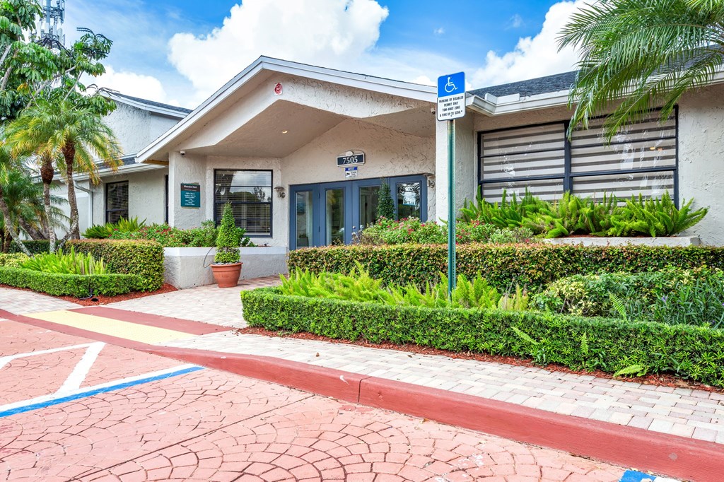 A building with a blue sign on a pole in front of it.