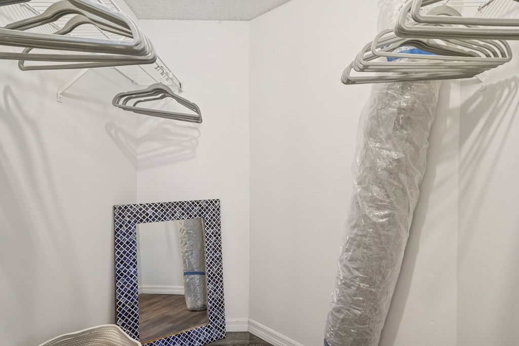 A mirror with a blue frame is on the floor.