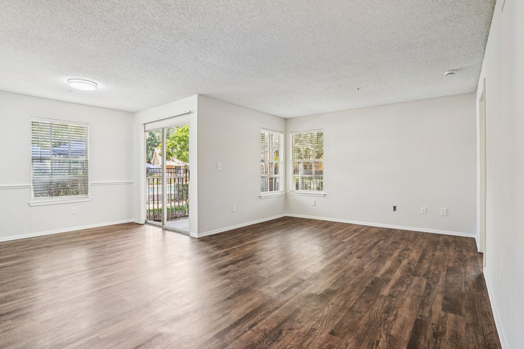 A room with wooden floors and white walls.