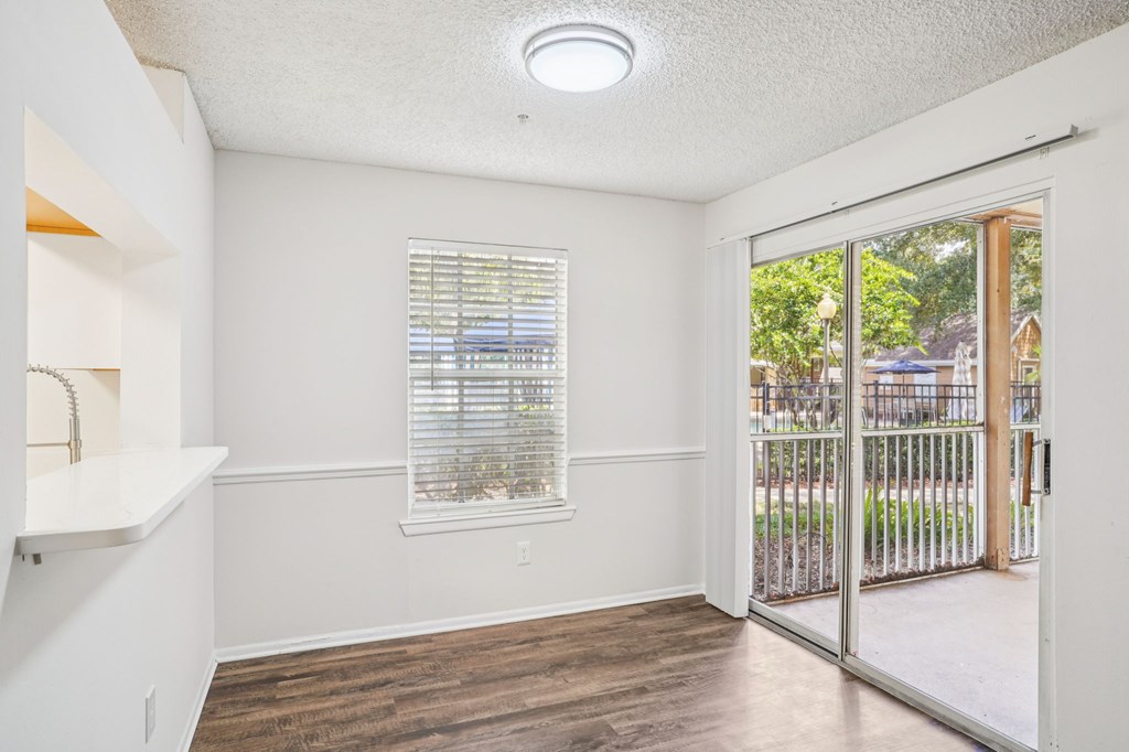 A room with a window and a sliding glass door.