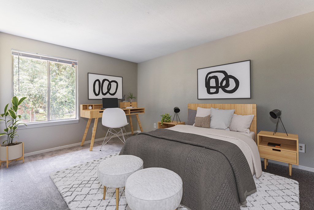 A bedroom with a bed, desk, and chair.