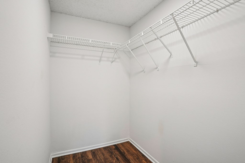 Empty room with white walls and wooden floor.