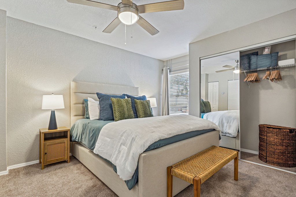 a bedroom with a large mirror and a ceiling fan at Reserve at Temple Terrace, Temple Terrace, FL 33637