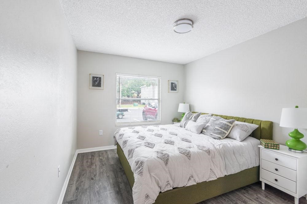 Bedroom with a bed and a window_Rolling Hills Apartments
