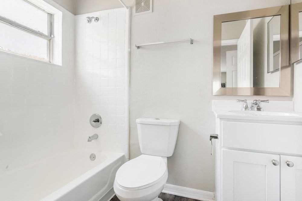 Restroom with a toilet, sink and bathtub_Rolling Hills Apartments