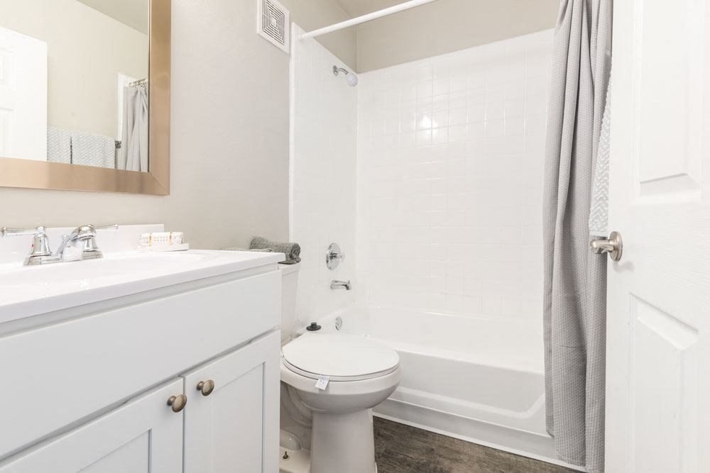 Bathroom with a sink, toilet and bathtub_Rolling Hills Apartments