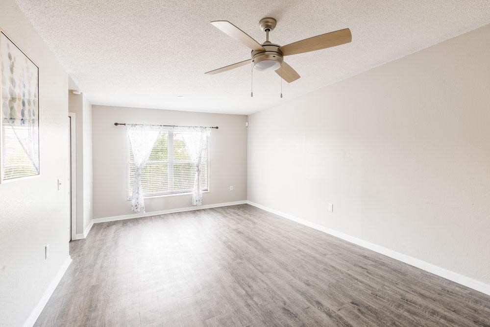 Empty living room with a ceiling fan_Rolling Hills Apartments