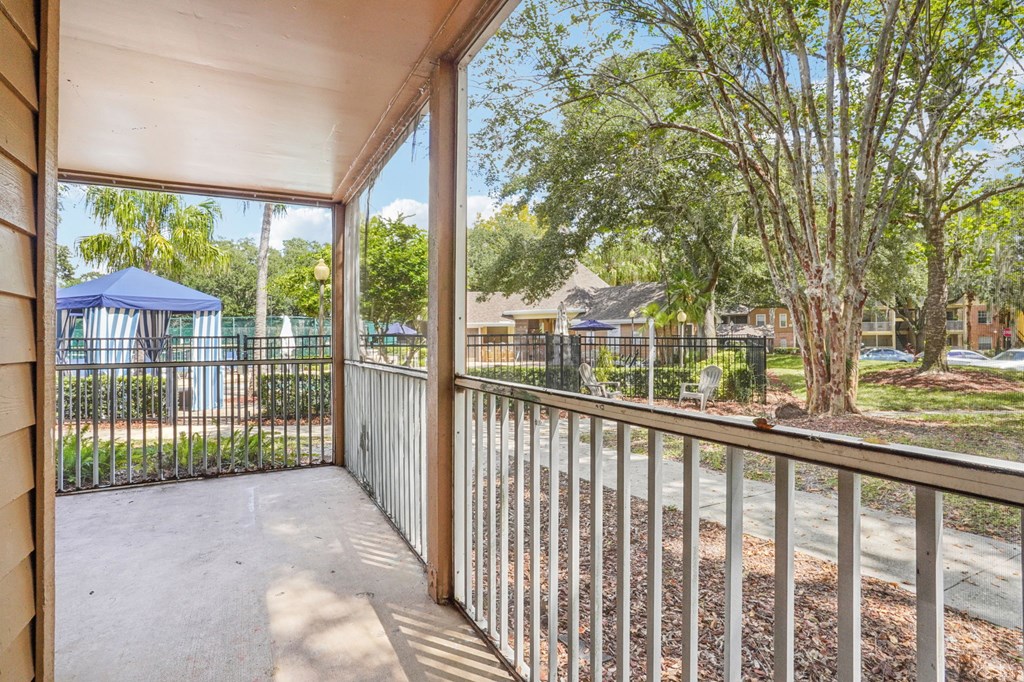A view from a balcony looking out at a playground and houses.