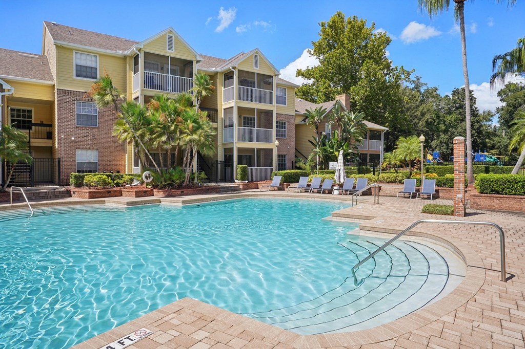 A swimming pool in front of a residential building.