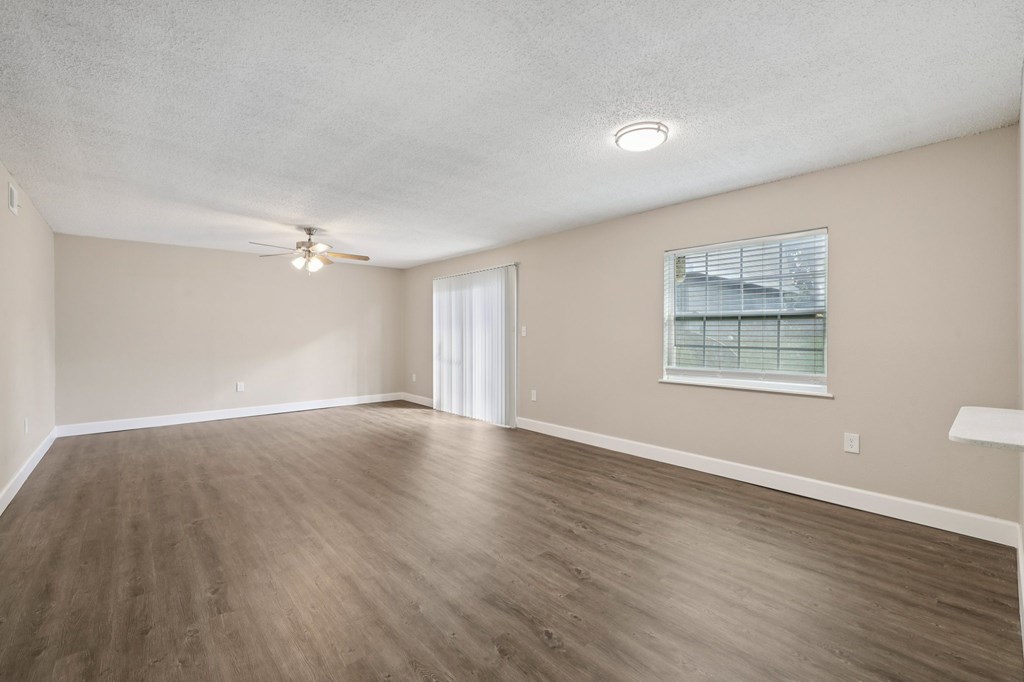 Empty room with wooden floor and white ceiling.