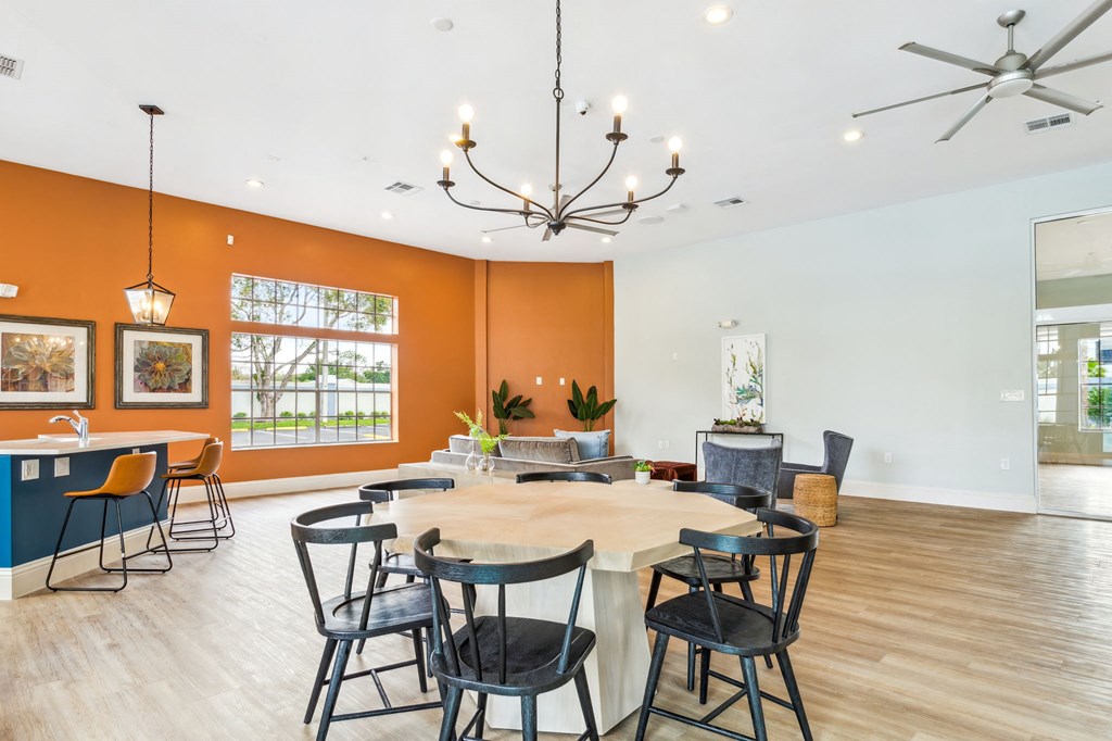 a club room with a large table and chairs at Reserve at Temple Terrace, Temple Terrace