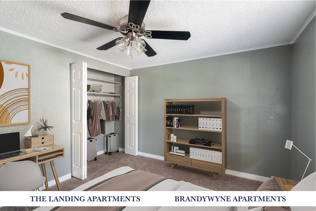 A room with a ceiling fan and a bookshelf.