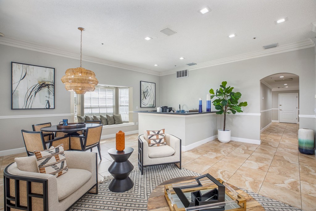 A living room with a sofa, armchair, and coffee table.
