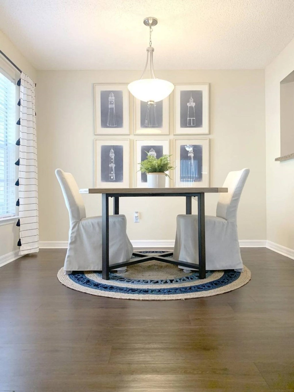 A dining room with a table and chairs.