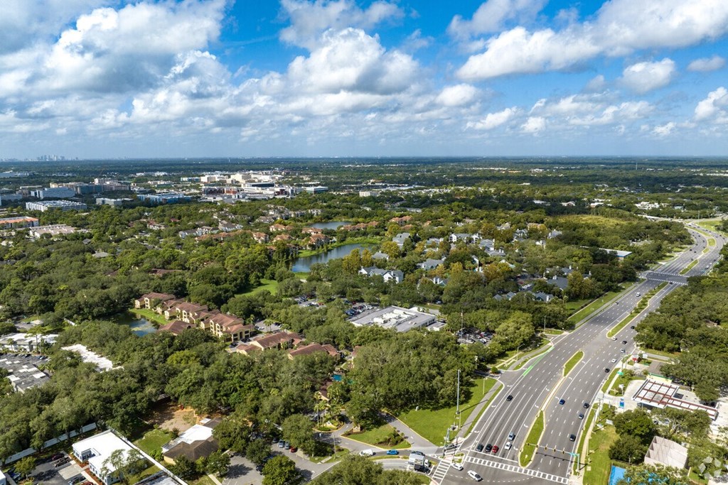 A bird's eye view of a suburban area with a road running through it.