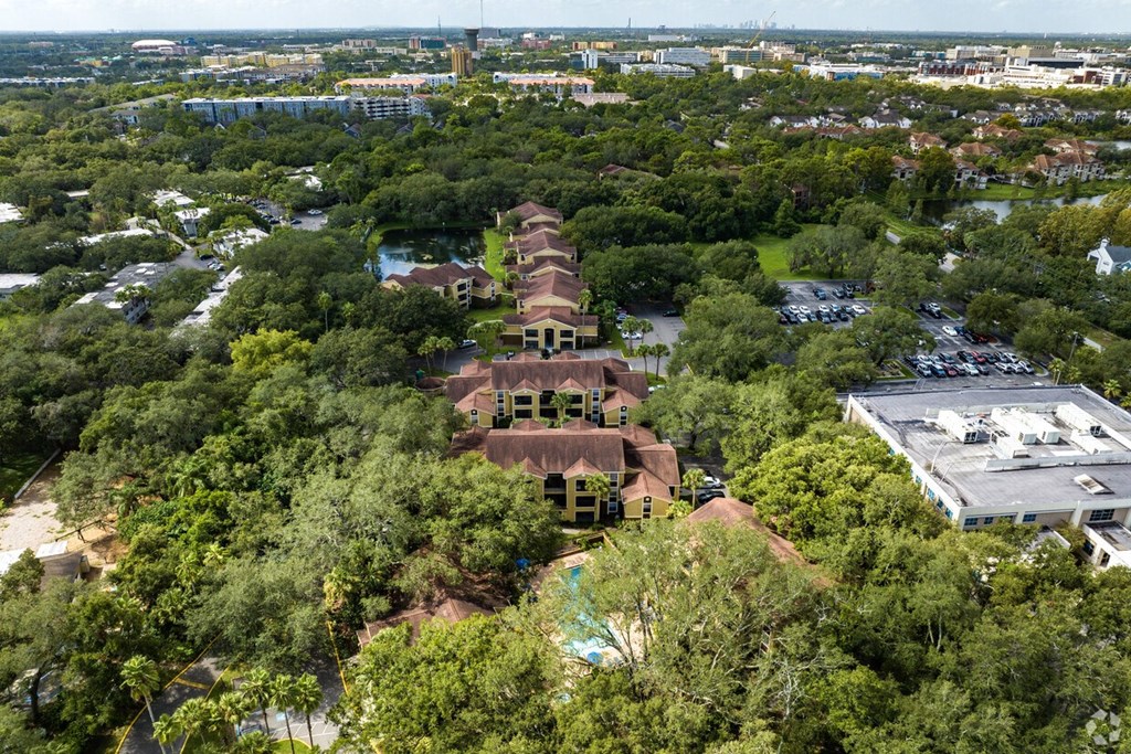 An aerial view of a large building surrounded by trees.