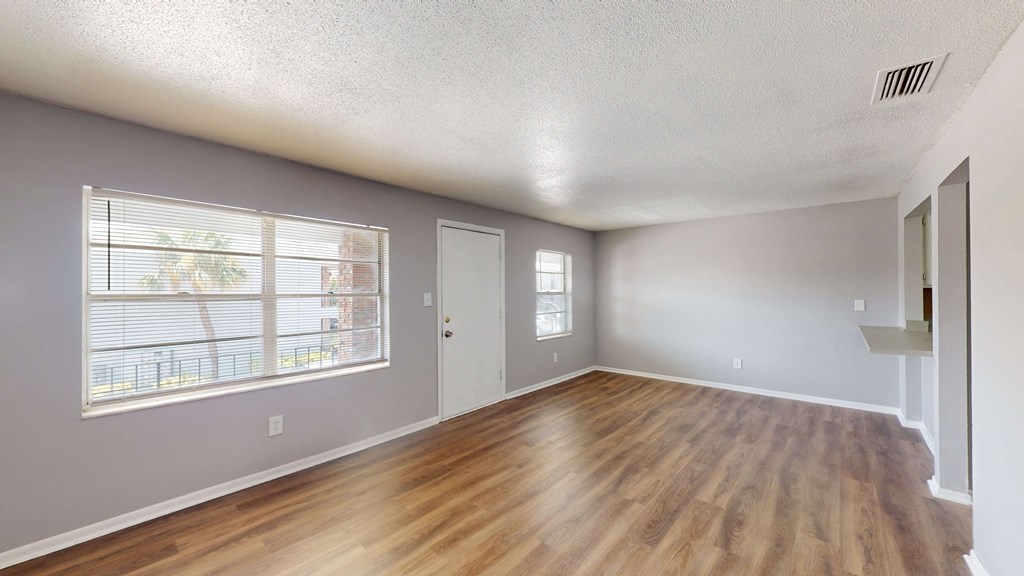a living room with hardwood floors and grey walls