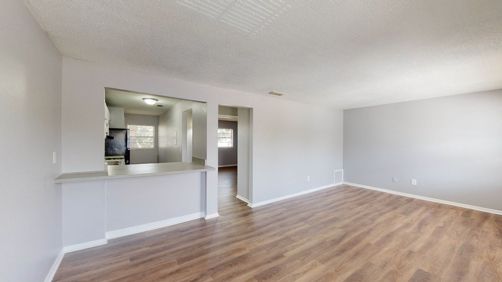 a living room with hardwood floors and grey walls