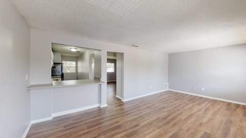 a living room with hardwood floors and grey walls
