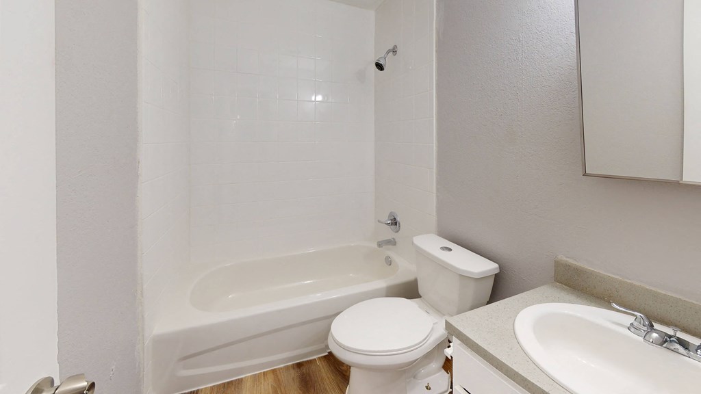a bathroom with a toilet sink and bathtub
